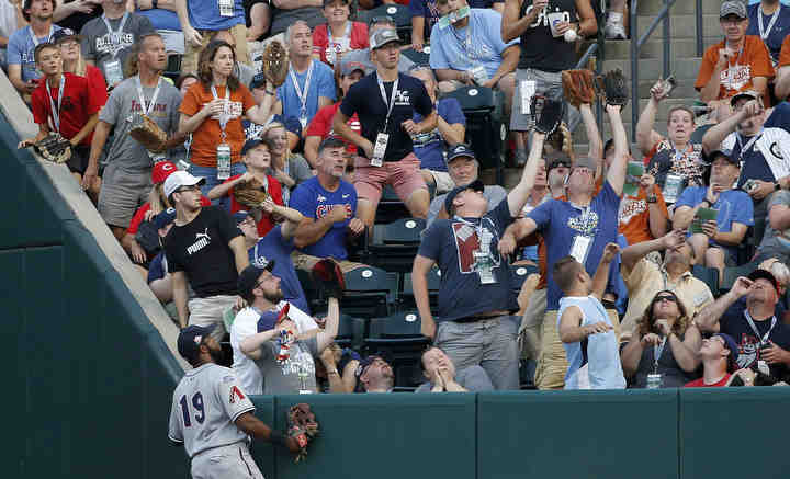 Fans reach for a foul ball from International League catcher Francisco Mejia (12) during the fourth inning of the Minor League Baseball Triple-A All-Star Game on at Huntington Park in Columbus.   (Joshua A. Bickel / The Columbus Dispatch)